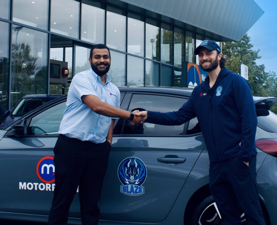 Head Coach Kevin Moore shakes hands with a Motorpoint representitive